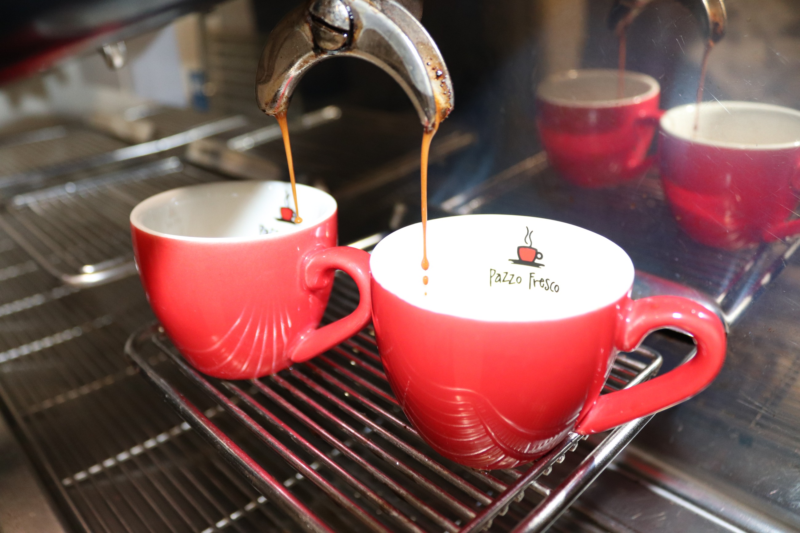 Espresso pouring into Pazzo Fresco cups