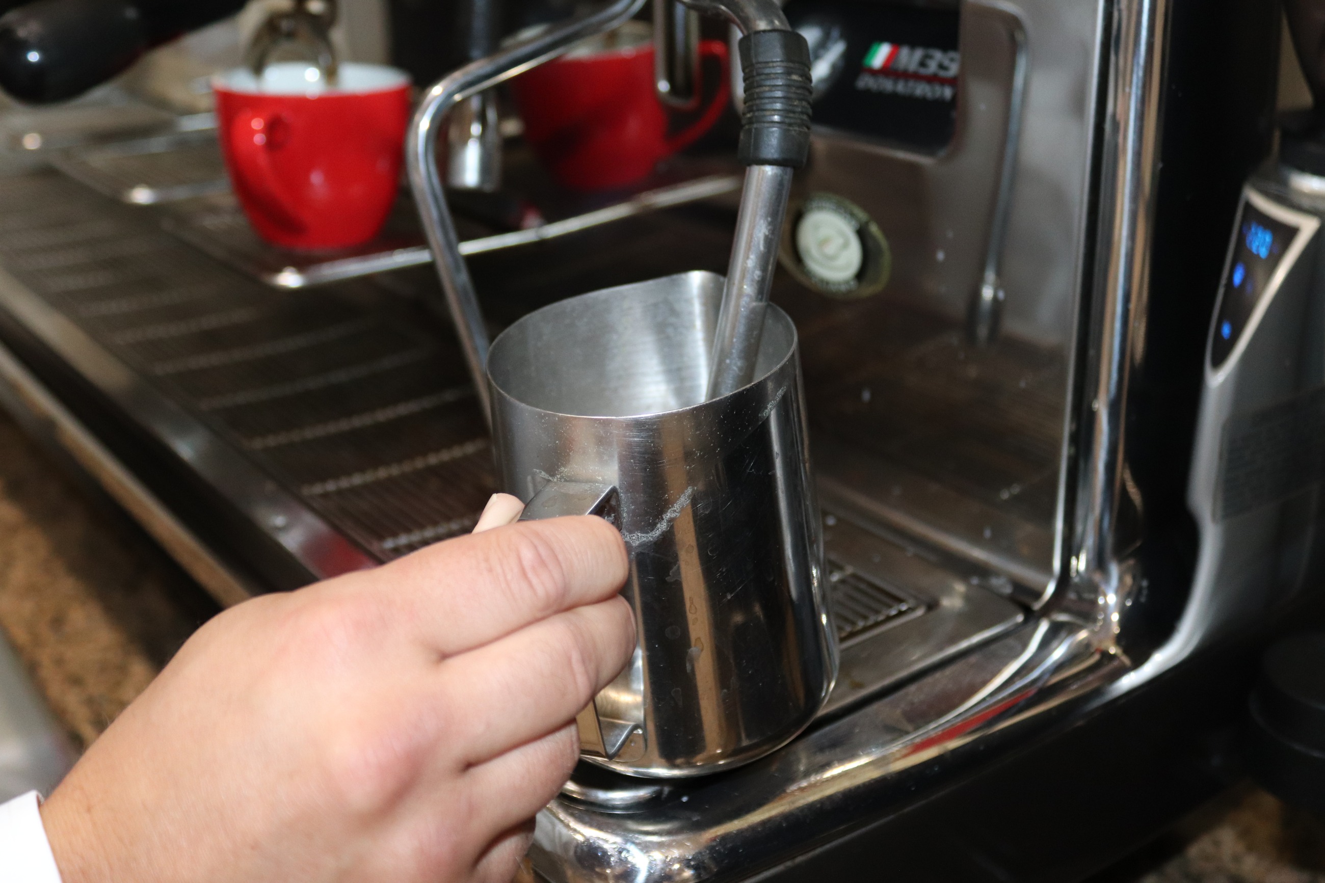 Steaming milk on a commercial espresso machine