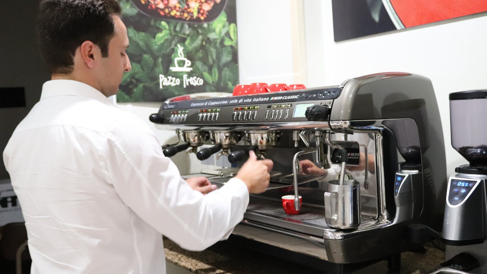 Barista pulling espresso at a commercial machine